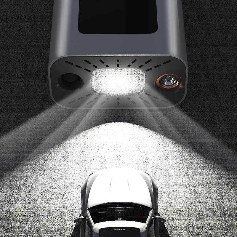 BCA portable digital tire inflator with built-in LED emergency light illuminating a parked car at night
